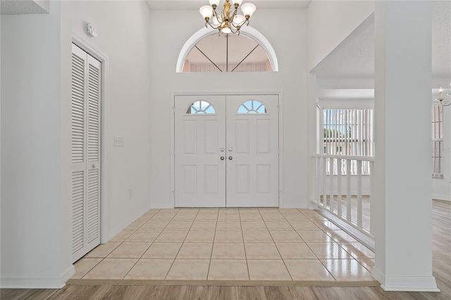11411 Terrell, Spring Hill, FL 34606 - foyer entrance featuring a chandelier, baseboards, a high ceiling, and tile patterned flooring