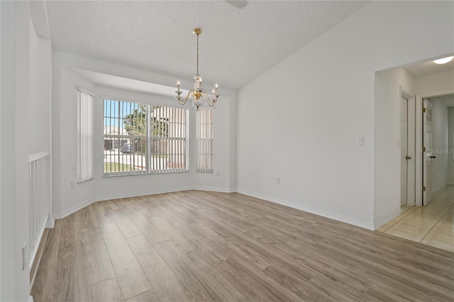 11411 Terrell, Spring Hill, FL 34606 - unfurnished dining area featuring a chandelier, light wood-type flooring, a textured ceiling, and baseboards
