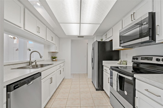 11411 Terrell, Spring Hill, FL 34606 - kitchen featuring appliances with stainless steel finishes, a sink, light countertops, white cabinets, and light tile patterned floors