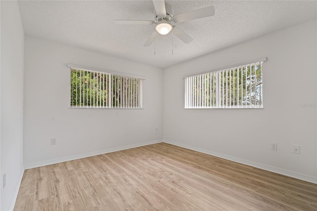 11411 Terrell, Spring Hill, FL 34606 - unfurnished room with wood finished floors, a textured ceiling, baseboards, and ceiling fan