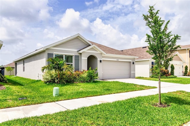 33668 Elm Hill Br, Wesley Chapel, FL 33545 - ranch-style house featuring stucco siding, an attached garage, driveway, and a front yard