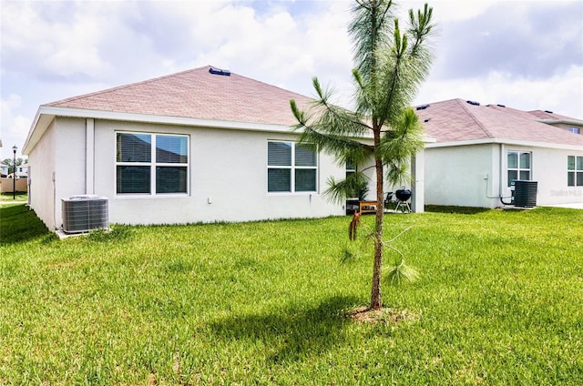 33668 Elm Hill Br, Wesley Chapel, FL 33545 - back of property with central AC, stucco siding, and a lawn