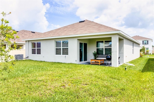 33668 Elm Hill Br, Wesley Chapel, FL 33545 - back of house featuring stucco siding, a yard, roof with shingles, and central AC
