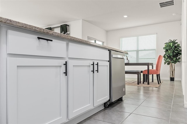 33668 Elm Hill Br, Wesley Chapel, FL 33545 - kitchen featuring light tile patterned floors, white cabinets, stainless steel dishwasher, recessed lighting, and light stone countertops