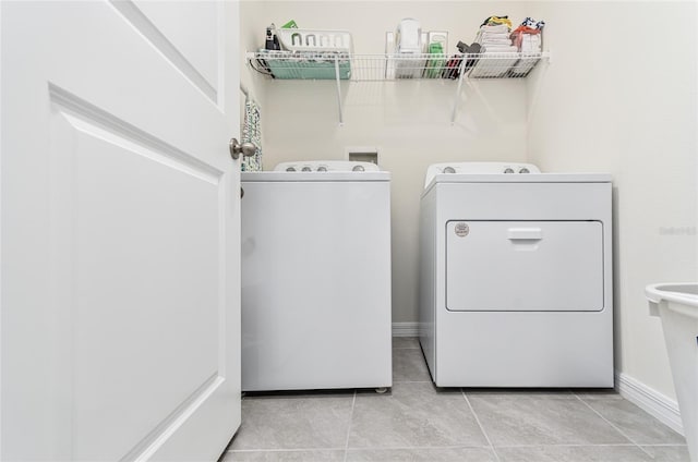 33668 Elm Hill Br, Wesley Chapel, FL 33545 - laundry room with washer and clothes dryer and tile patterned floors
