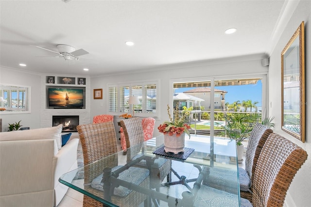433 S Paula Dr Unit 31, Dunedin, FL 34698 - dining area featuring crown molding, recessed lighting, a fireplace, ceiling fan, and french doors