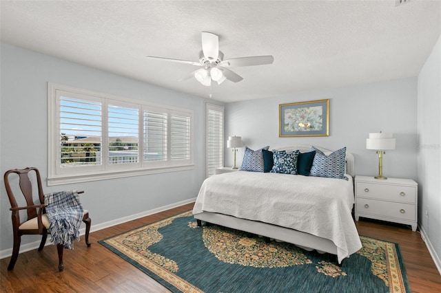 433 S Paula Dr Unit 31, Dunedin, FL 34698 - bedroom featuring wood finished floors, a textured ceiling, and a ceiling fan