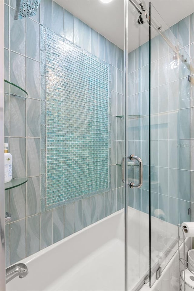 433 S Paula Dr Unit 31, Dunedin, FL 34698 - full bathroom featuring shower / bath combination with glass door