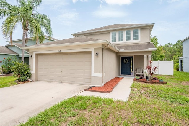12624 White Bluff Rd, Hudson, FL 34669 - traditional-style home featuring stucco siding, an attached garage, and concrete driveway