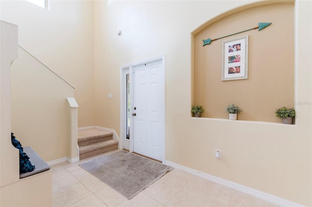 12624 White Bluff Rd, Hudson, FL 34669 - entryway with stairs, light tile patterned floors, and baseboards