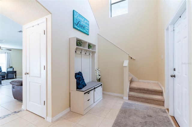 12624 White Bluff Rd, Hudson, FL 34669 - entrance foyer featuring stairway, light tile patterned flooring, baseboards, and a towering ceiling