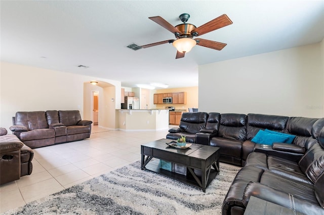 12624 White Bluff Rd, Hudson, FL 34669 - living area featuring a ceiling fan, arched walkways, and light tile patterned floors