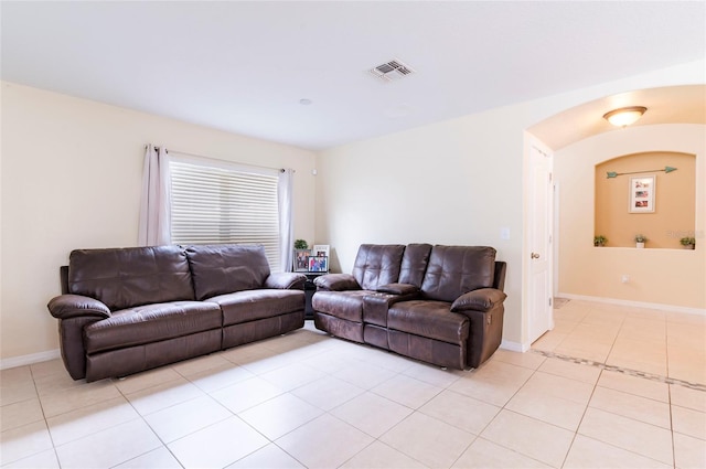 12624 White Bluff Rd, Hudson, FL 34669 - living room with light tile patterned flooring, baseboards, and arched walkways