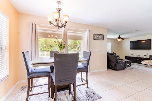 12624 White Bluff Rd, Hudson, FL 34669 - dining space featuring a chandelier, a ceiling fan, light tile patterned floors, and baseboards