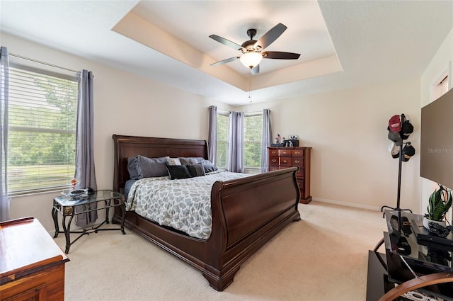 12624 White Bluff Rd, Hudson, FL 34669 - bedroom with light colored carpet, multiple windows, and a tray ceiling
