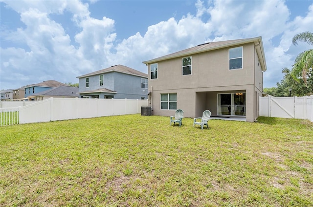 12624 White Bluff Rd, Hudson, FL 34669 - back of house featuring stucco siding and central AC