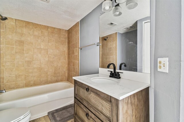 1967 Cormorant Ct Unit 515, Clearwater, FL 33762 - full bath featuring toilet, vanity, tub / shower combination, and a textured ceiling