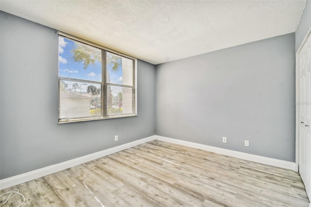 1967 Cormorant Ct Unit 515, Clearwater, FL 33762 - spare room with a textured ceiling, wood finished floors, and baseboards