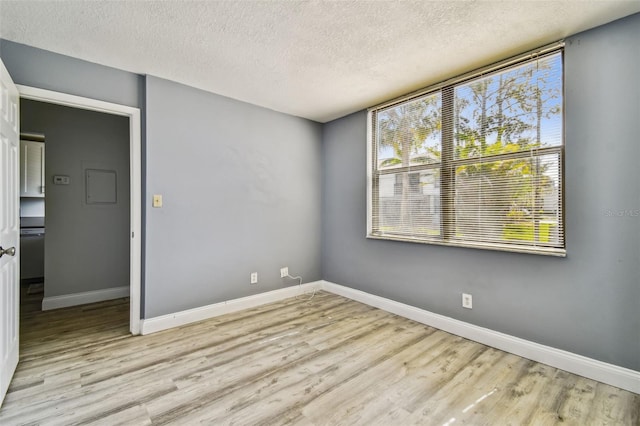 1967 Cormorant Ct Unit 515, Clearwater, FL 33762 - spare room with a textured ceiling, light wood-style floors, and baseboards