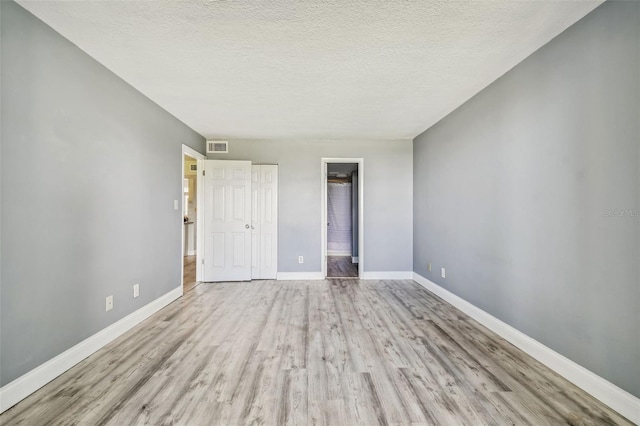 1967 Cormorant Ct Unit 515, Clearwater, FL 33762 - unfurnished bedroom with wood finished floors, baseboards, and a textured ceiling
