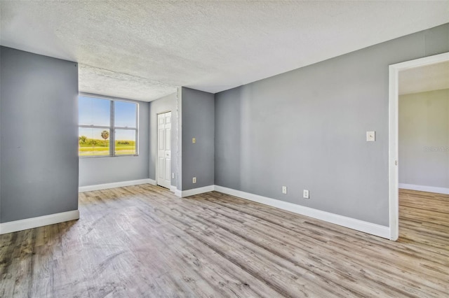 1967 Cormorant Ct Unit 515, Clearwater, FL 33762 - spare room with wood finished floors, a textured ceiling, and baseboards