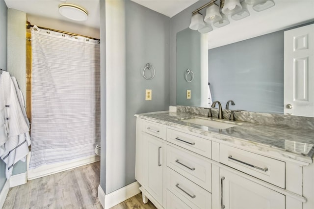 1967 Cormorant Ct Unit 515, Clearwater, FL 33762 - bathroom with vanity, baseboards, wood finished floors, toilet, and a shower with shower curtain