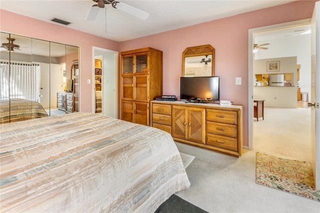 70 Morning Dove Pl, Oldsmar, FL 34677 - bedroom with light carpet, freestanding refrigerator, and a ceiling fan