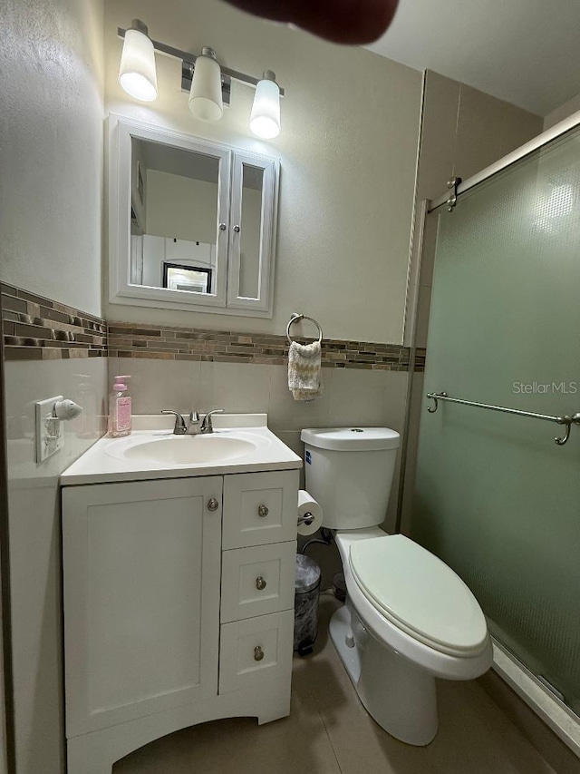 5860 43rd Ter N Unit 1518, Kenneth City, FL 33709 - full bath featuring toilet, vanity, a stall shower, tile patterned floors, and tile walls