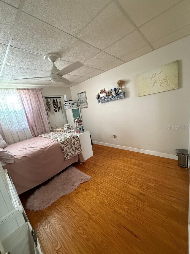 5860 43rd Ter N Unit 1518, Kenneth City, FL 33709 - bedroom featuring wood finished floors, baseboards, a paneled ceiling, and ceiling fan