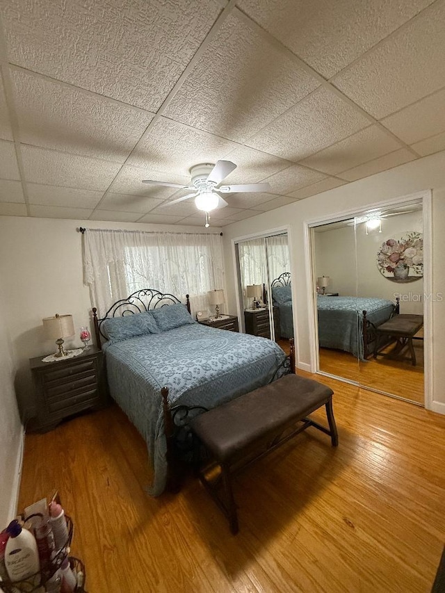 5860 43rd Ter N Unit 1518, Kenneth City, FL 33709 - bedroom with two closets, light wood finished floors, ceiling fan, and a paneled ceiling