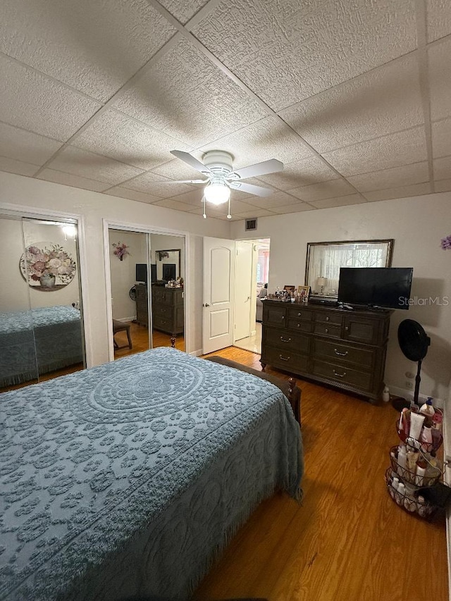 5860 43rd Ter N Unit 1518, Kenneth City, FL 33709 - bedroom with wood finished floors, a paneled ceiling, multiple closets, and ceiling fan