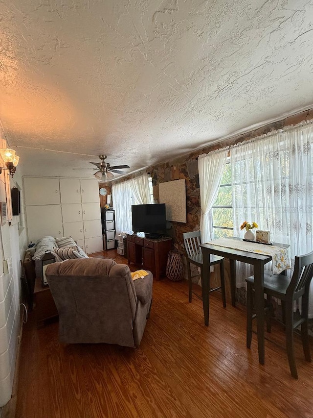 5860 43rd Ter N Unit 1518, Kenneth City, FL 33709 - living area featuring a textured ceiling, wood finished floors, and a ceiling fan