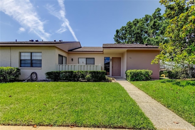 50 Ingrid Pl Unit 50, Oldsmar, FL 34677 - view of front of house featuring stucco siding and a front yard