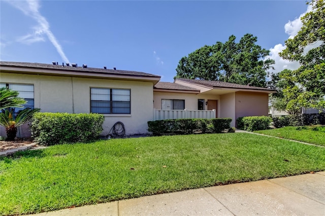 50 Ingrid Pl Unit 50, Oldsmar, FL 34677 - view of front of house with stucco siding and a front yard