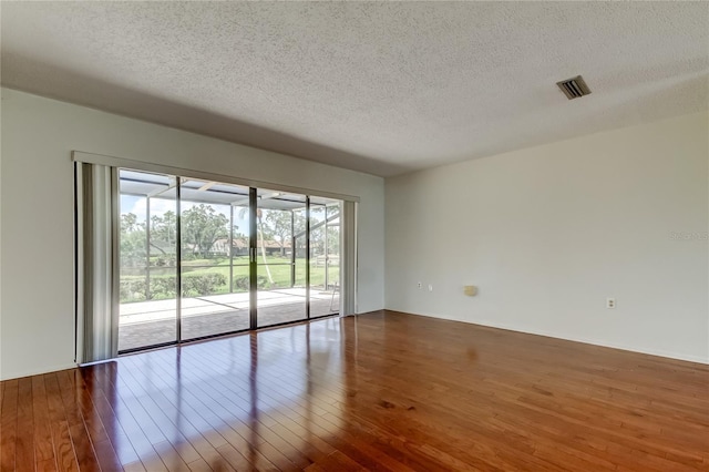50 Ingrid Pl Unit 50, Oldsmar, FL 34677 - unfurnished room featuring a textured ceiling and hardwood / wood-style floors