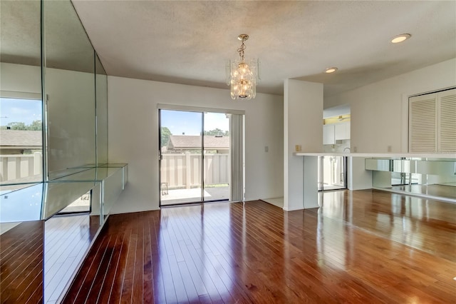 50 Ingrid Pl Unit 50, Oldsmar, FL 34677 - empty room featuring a chandelier, wood-type flooring, and recessed lighting