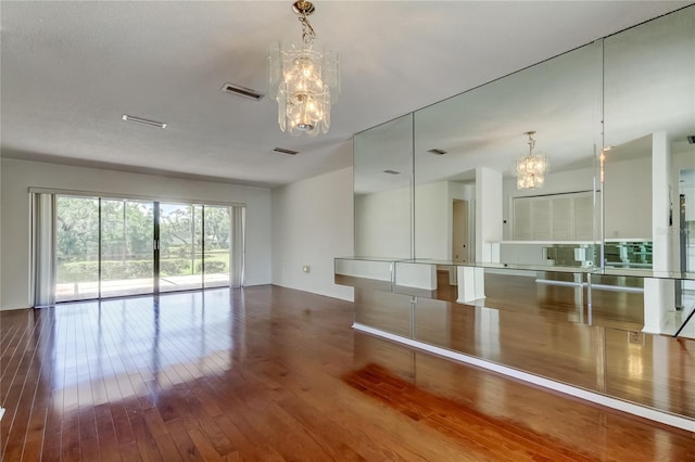 50 Ingrid Pl Unit 50, Oldsmar, FL 34677 - spare room with a chandelier and hardwood / wood-style flooring