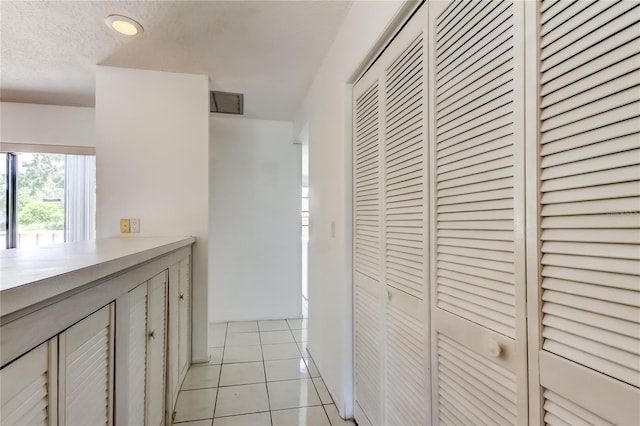 50 Ingrid Pl Unit 50, Oldsmar, FL 34677 - corridor with light tile patterned floors and a textured ceiling