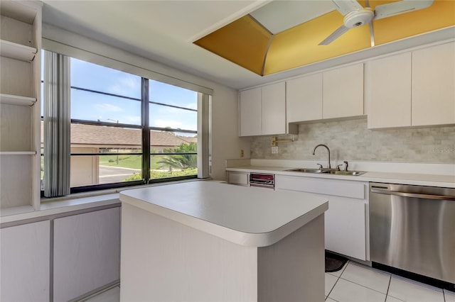 50 Ingrid Pl Unit 50, Oldsmar, FL 34677 - kitchen with stainless steel dishwasher, a sink, light countertops, light tile patterned floors, and decorative backsplash