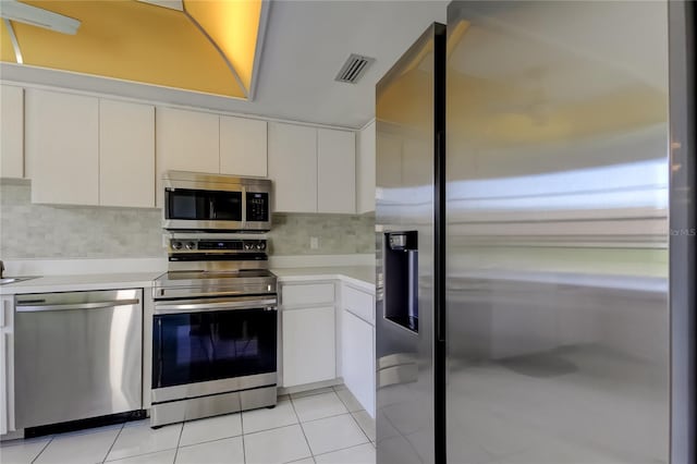 50 Ingrid Pl Unit 50, Oldsmar, FL 34677 - kitchen with stainless steel appliances, light countertops, backsplash, and white cabinets