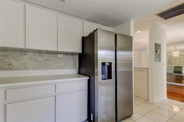 50 Ingrid Pl Unit 50, Oldsmar, FL 34677 - kitchen with stainless steel refrigerator with ice dispenser, light tile patterned flooring, electric panel, light countertops, and white cabinets