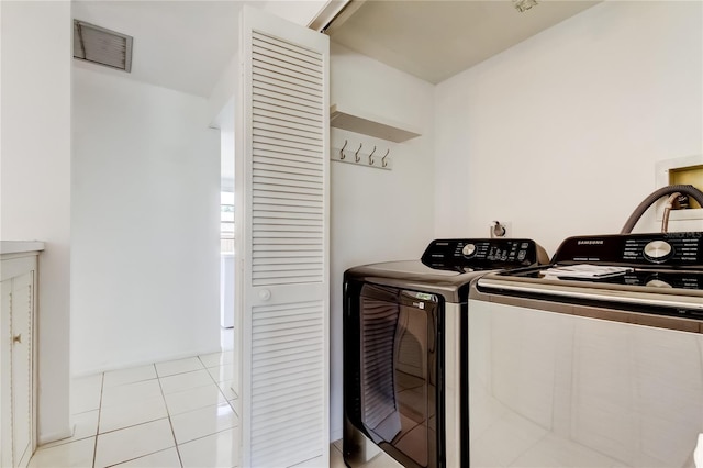 50 Ingrid Pl Unit 50, Oldsmar, FL 34677 - laundry room with washer and dryer and light tile patterned floors