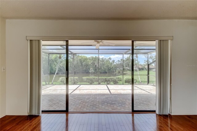 50 Ingrid Pl Unit 50, Oldsmar, FL 34677 - doorway with ceiling fan, hardwood / wood-style floors, and a sunroom