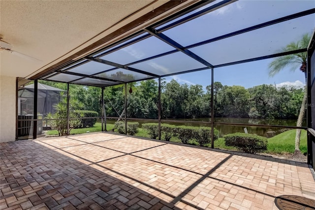 50 Ingrid Pl Unit 50, Oldsmar, FL 34677 - view of patio / terrace with a water view, glass enclosure, and view of wooded area