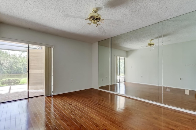 50 Ingrid Pl Unit 50, Oldsmar, FL 34677 - unfurnished room with a ceiling fan, a textured ceiling, wood finished floors, and baseboards