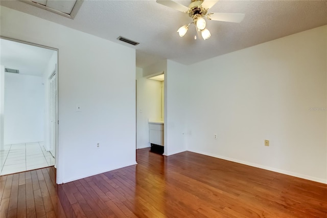 50 Ingrid Pl Unit 50, Oldsmar, FL 34677 - spare room featuring wood finished floors, a ceiling fan, and a textured ceiling