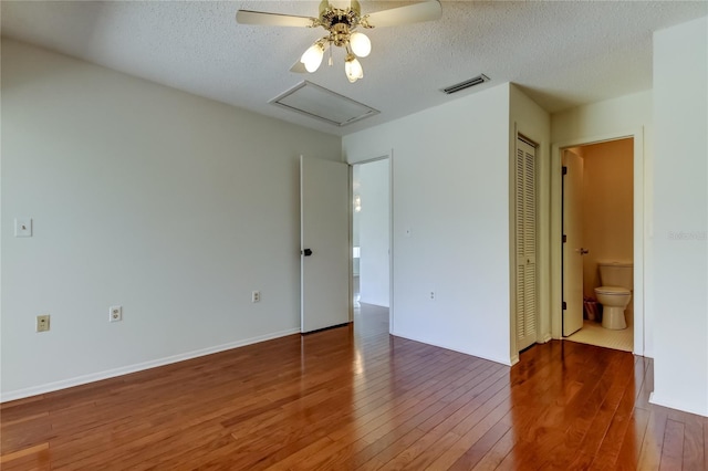 50 Ingrid Pl Unit 50, Oldsmar, FL 34677 - unfurnished bedroom with hardwood / wood-style flooring, attic access, a textured ceiling, a closet, and connected bathroom