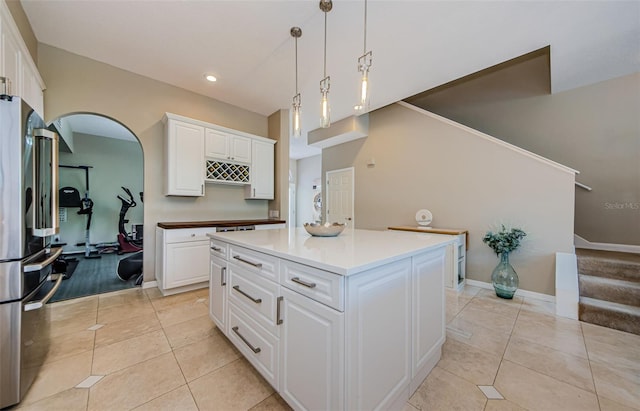 1710 Lago Vista Blvd, Palm Harbor, FL 34685 - kitchen with freestanding refrigerator, light tile patterned floors, white cabinets, and recessed lighting