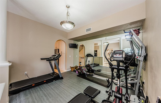 1710 Lago Vista Blvd, Palm Harbor, FL 34685 - exercise room with arched walkways and baseboards