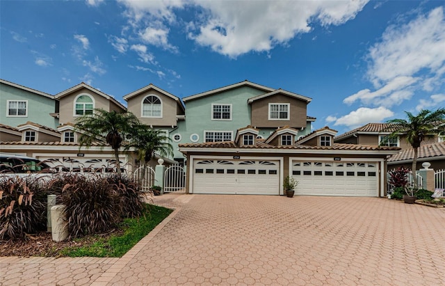 1710 Lago Vista Blvd, Palm Harbor, FL 34685 - view of front of home featuring a gate, decorative driveway, and stucco siding